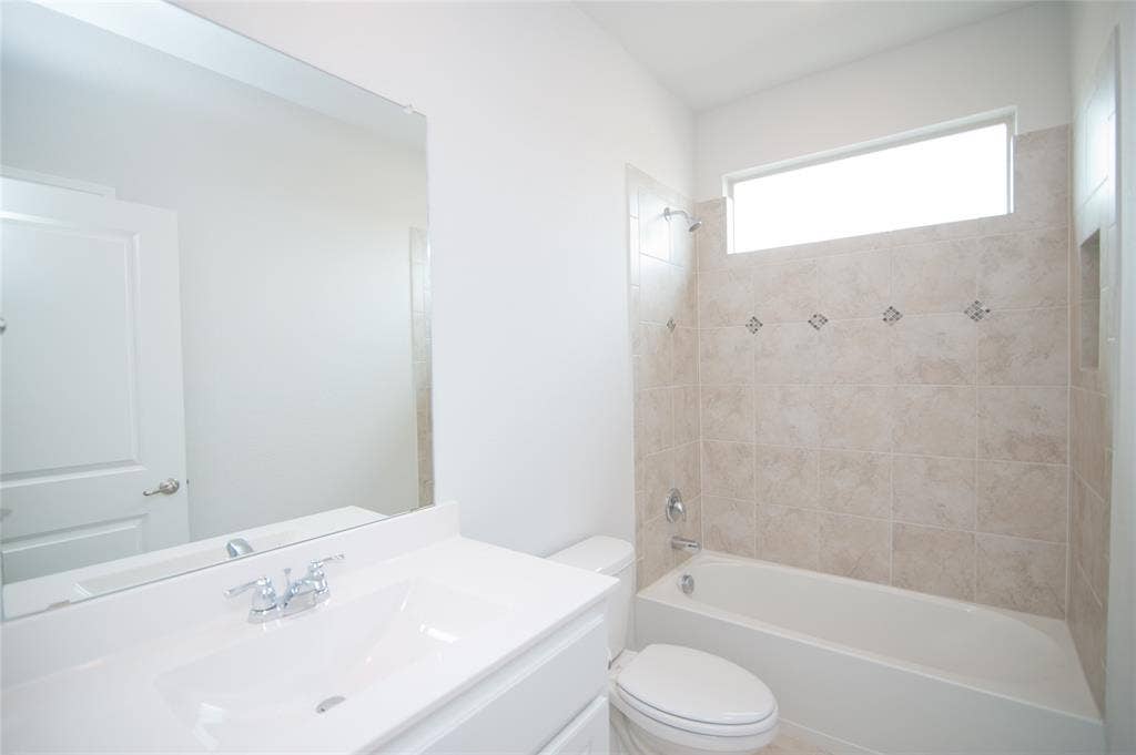 1021 Gillespie Drive, Fort Worth, TX 76247 White vanity with an integrated sink and chrome faucet