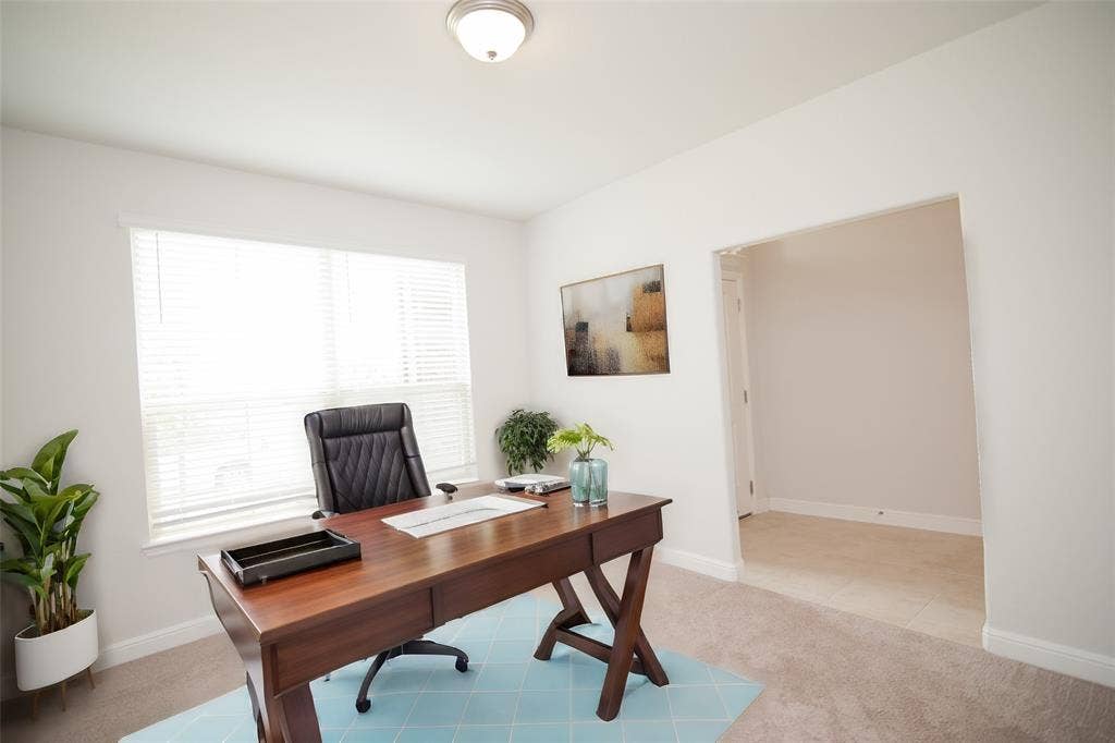 1021 Gillespie Drive, Fort Worth, TX 76247 Recessed lighting, large window with blinds, neutral carpeting, and a broad arched doorway