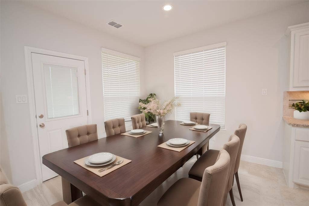 1021 Gillespie Drive, Fort Worth, TX 76247 Bright dining space featuring a large window with blinds, recessed lighting, and tile flooring