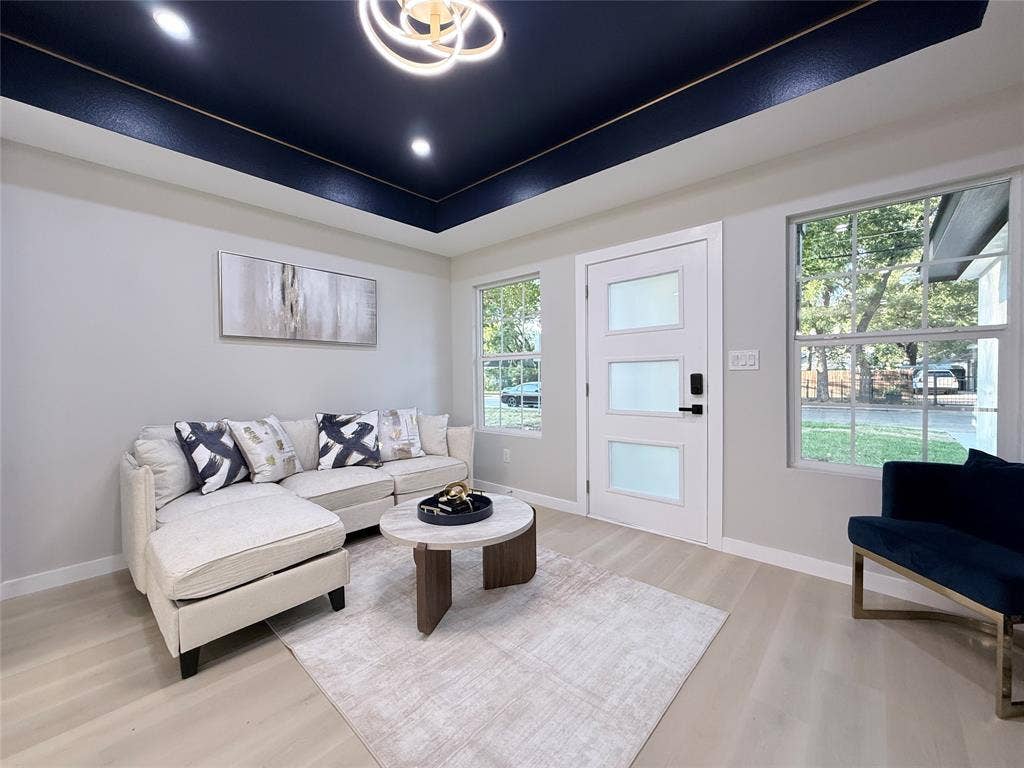 2538 Hooper Street, Dallas, TX 75215 Recessed ceiling with an accent color, contemporary chandelier, white walls, light wood-finish flooring, and a modern entry door with frosted panels
