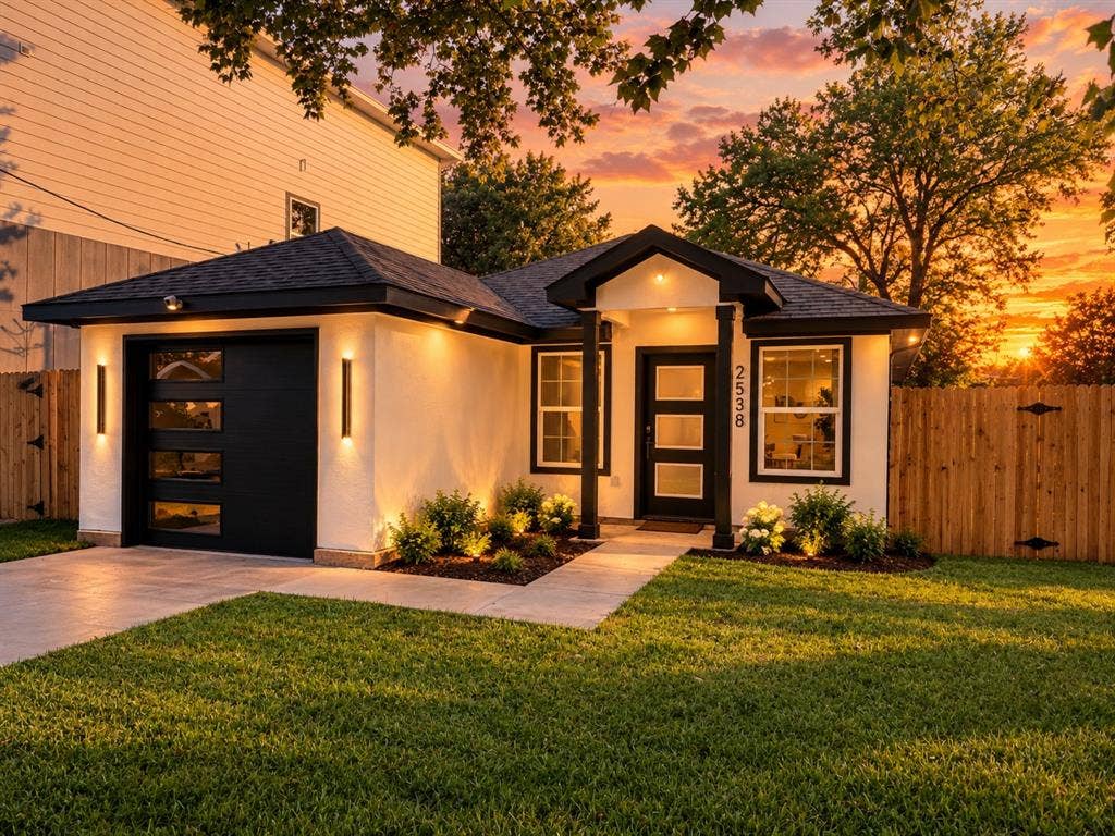 2538 Hooper Street, Dallas, TX 75215 Modern exterior with a black trim roofline, stucco siding, and a wood privacy fence