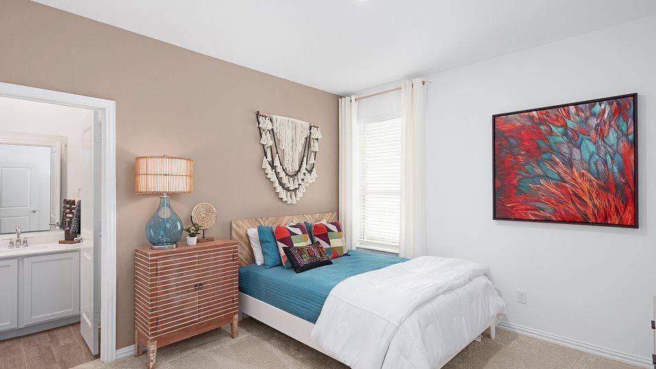Carpeted bedroom with a window featuring blinds, a neutral wall color, and an adjacent bathroom with a vanity and wood-finish flooring