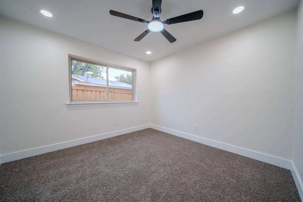 Recessed lighting, ceiling fan, neutral wall paint, window, and carpeting