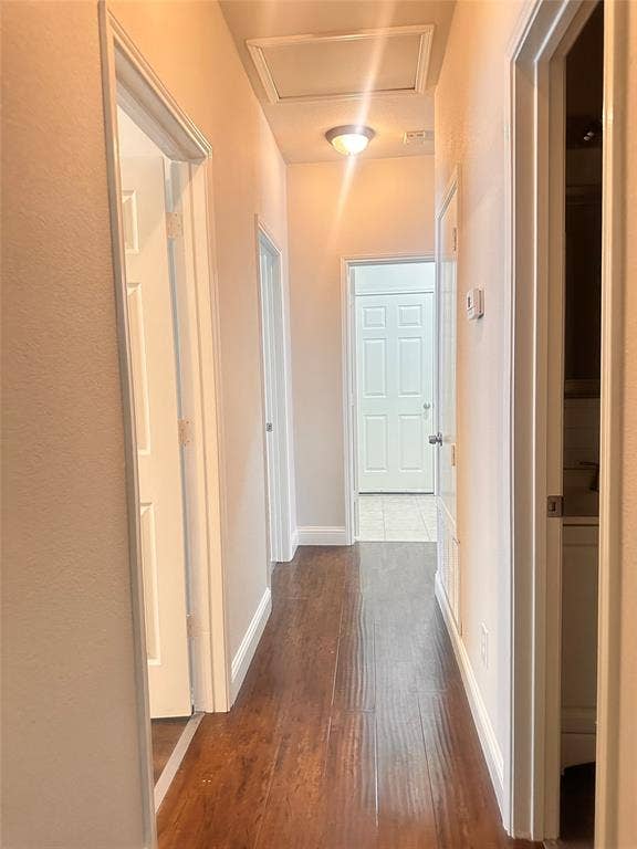 12262 PEAK Circle, Frisco, TX 75035 Hall with dark wood-type flooring and baseboards