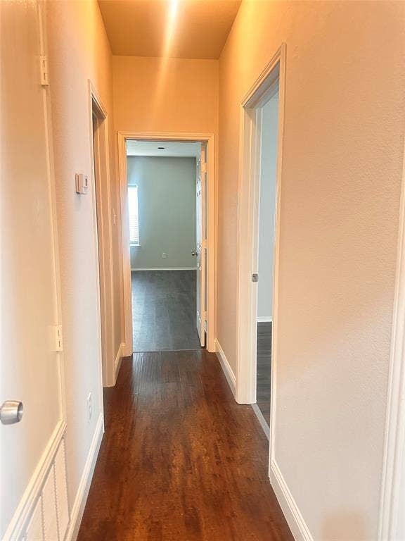 12262 PEAK Circle, Frisco, TX 75035 Hallway featuring dark wood finished floors and baseboards