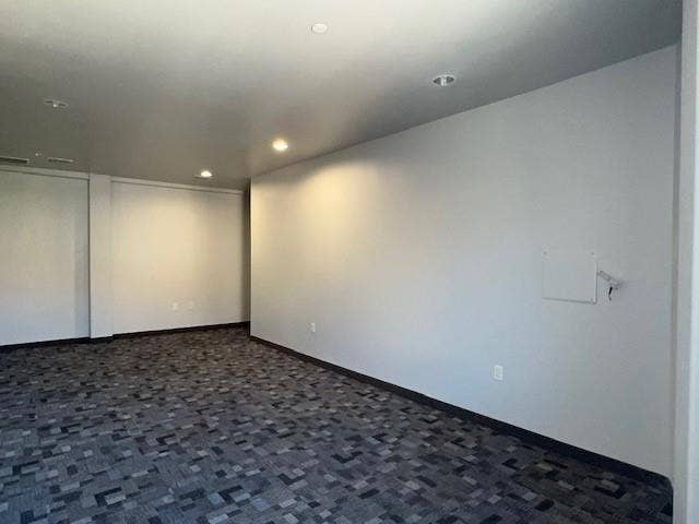 Recessed lighting, light gray wall finishes, patterned carpet flooring, and a white access panel