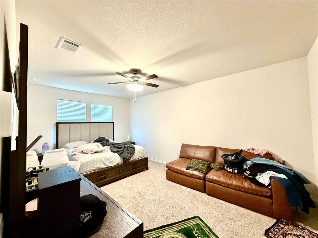 Carpeted room featuring a ceiling fan, dual windows with blinds, and recessed lighting