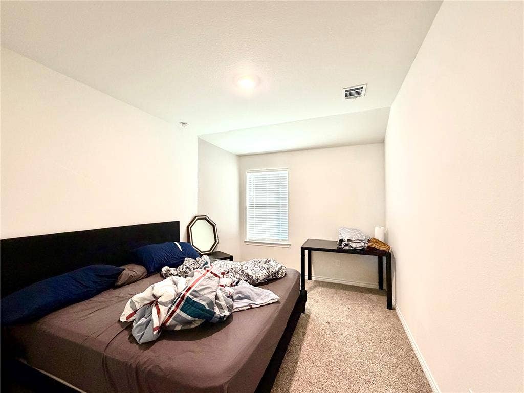 Neutral wall finishes, recessed lighting, window with horizontal blinds, and carpeting