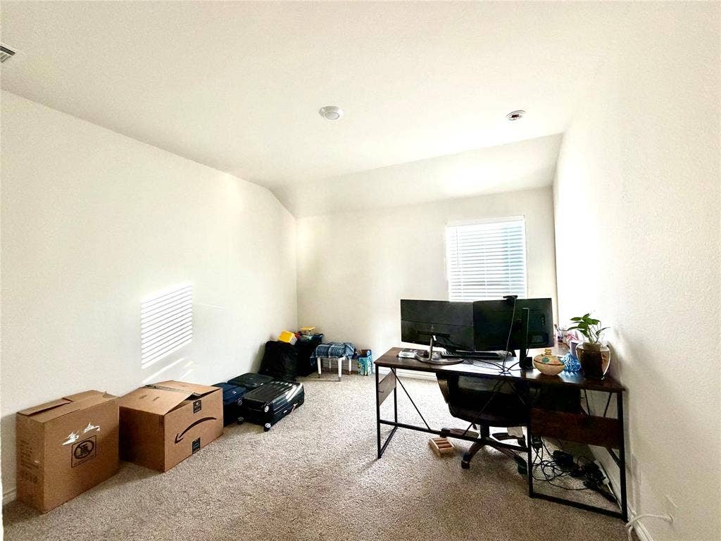 Recessed ceiling lighting, textured wall finish, window with horizontal blinds, and carpeting
