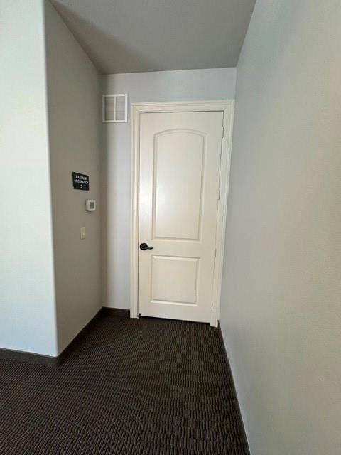 White paneled door with black hardware