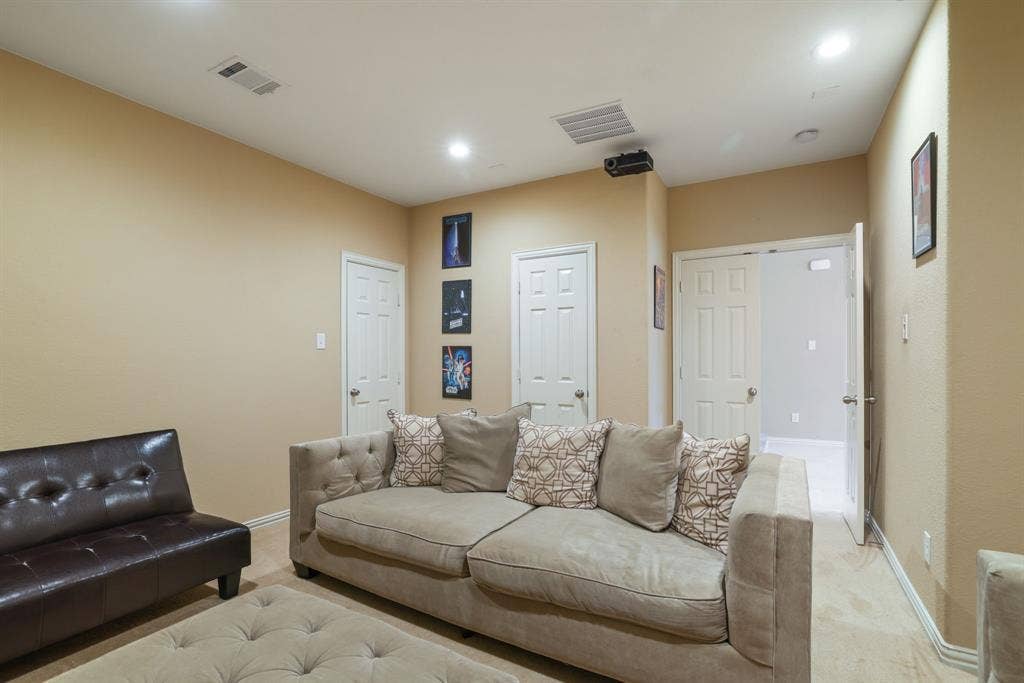 1213 Egret Court, Little Elm, TX 75068 Recessed ceiling lighting, ceiling-mounted projector, wall-mounted air vent, neutral wall paint, and white paneled doors