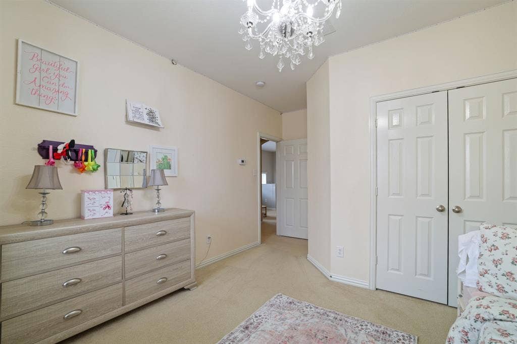 1213 Egret Court, Little Elm, TX 75068 Recessed lighting, chandelier, neutral tone walls, bi-fold closet doors, and light-colored carpet