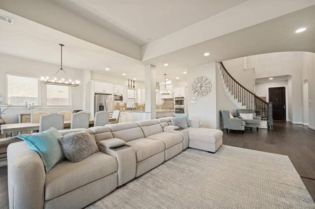 2721 Old Shire Path Road, Prosper, TX 75078 Open-concept living area with dark wood-finish flooring, white walls, and recessed lighting