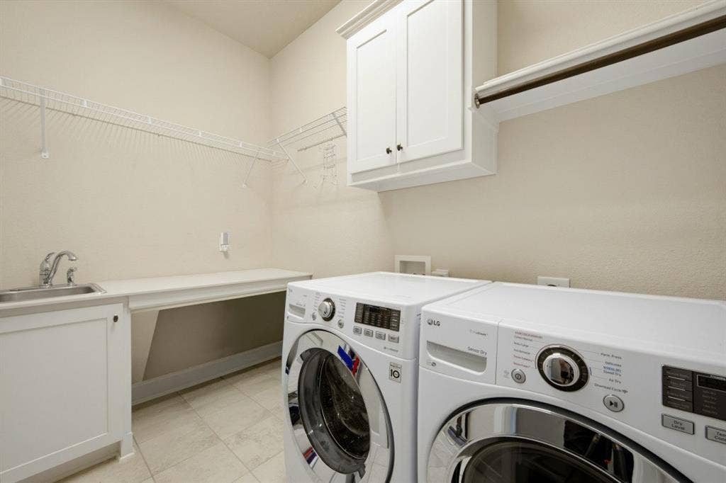 2721 Old Shire Path Road, Prosper, TX 75078 Utility room featuring a built-in sink, white cabinetry, wire shelving, and a hanging rod