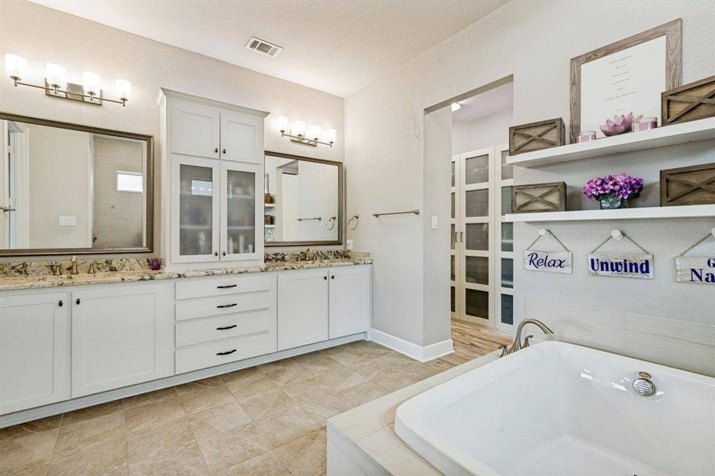 2721 Old Shire Path Road, Prosper, TX 75078 Dual vanity with granite countertops, white cabinetry, and individual framed mirrors