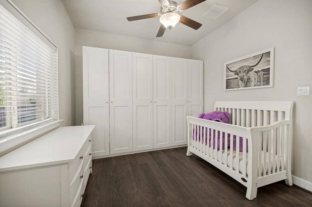 2721 Old Shire Path Road, Prosper, TX 75078 Wood-finish flooring, built-in white cabinetry, vaulted ceiling, window with blinds, and ceiling fan with integrated lighting