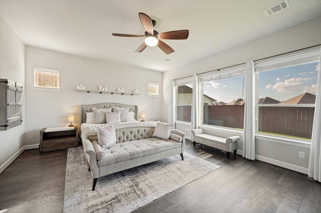 2721 Old Shire Path Road, Prosper, TX 75078 Dark wood-finish flooring, ceiling fan with integrated lighting, multiple large windows, window blinds, and recessed lighting