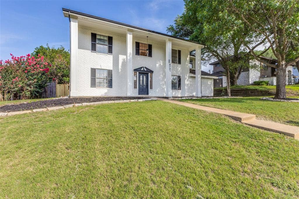 4721 Fallon Place, Dallas, TX 75227 Two-story white brick exterior with black shutters and a prominent front entrance