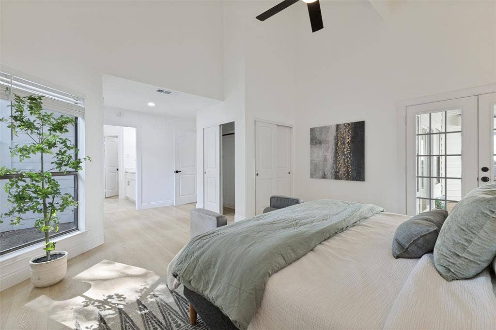 4721 Fallon Place, Dallas, TX 75227 Primary bedroom with a vaulted ceiling, ceiling fan, luxury vinyl plank flooring, and French doors with divided lites