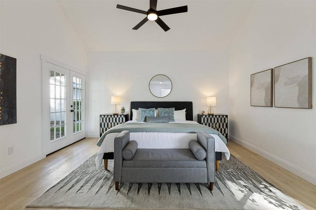 4721 Fallon Place, Dallas, TX 75227 First-floor primary bedroom with a vaulted ceiling, luxury vinyl plank flooring, ceiling fan, and French doors