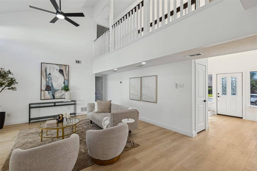 4721 Fallon Place, Dallas, TX 75227 Vaulted ceilings with an overhead fan, luxury vinyl plank flooring, white painted walls, and a prominent white entry door with decorative glass inserts