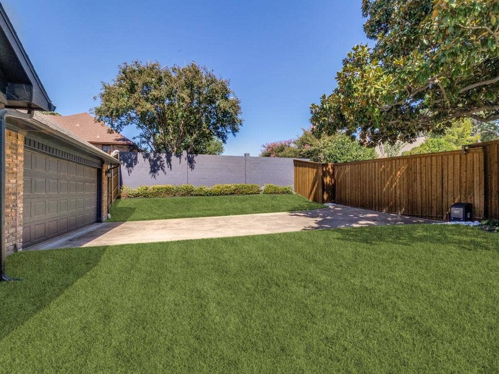 Huge grassy yard with spacious driveway and electric gate