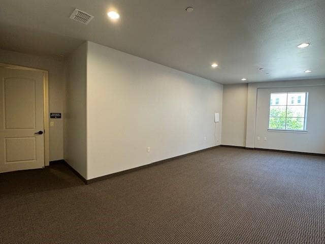 Recessed lighting fixtures, broad window, and neutral wall tones