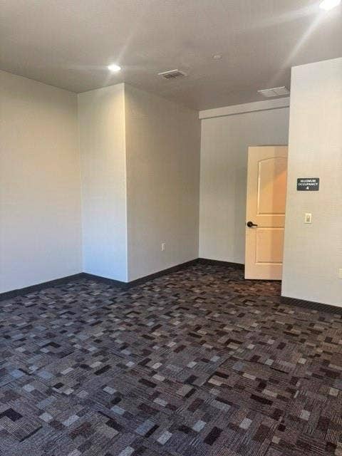 6675 Mediterranean Drive, #202, McKinney, TX 75072 Recessed lighting, light gray walls, patterned carpet flooring, and a white interior door with a dark handle