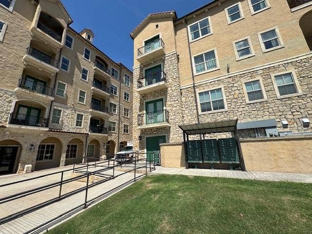6675 Mediterranean Drive, #202, McKinney, TX 75072 Stone and stucco exterior with multiple balconies, archways, and a paved walkway
