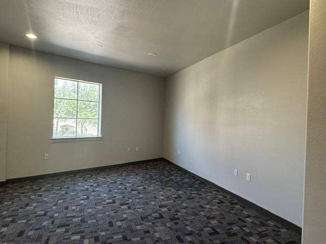 6675 Mediterranean Drive, #202, McKinney, TX 75072 Window with exterior scenery, overhead recessed lighting, and patterned carpet