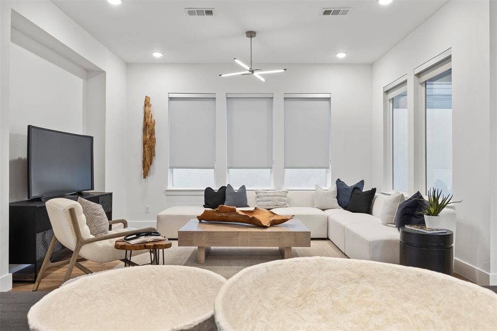 This property features a truly expansive and inviting living space that is highlighted by a seamless, modern open floor plan and bathed in an incredible amount of warm, abundant natural light throughout the day.