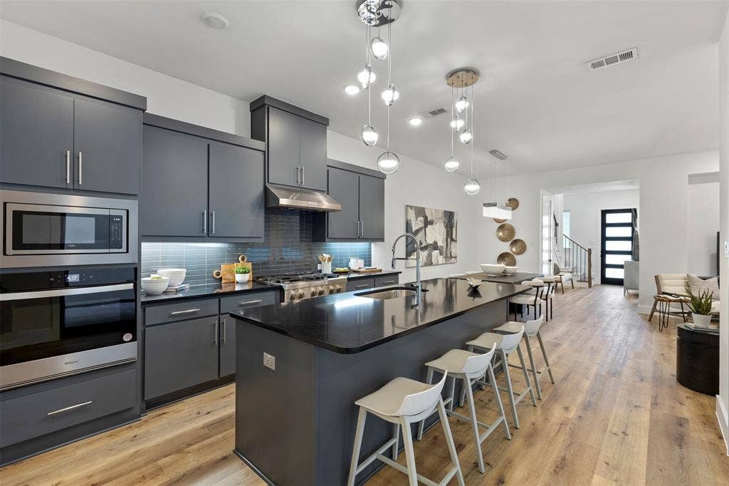 This expansive and inviting great room is perfectly designed for both effortless entertaining and comfortable daily living, featuring an open layout that seamlessly blends functionality with modern style to create the ultimate gathering space for family and guests alike.