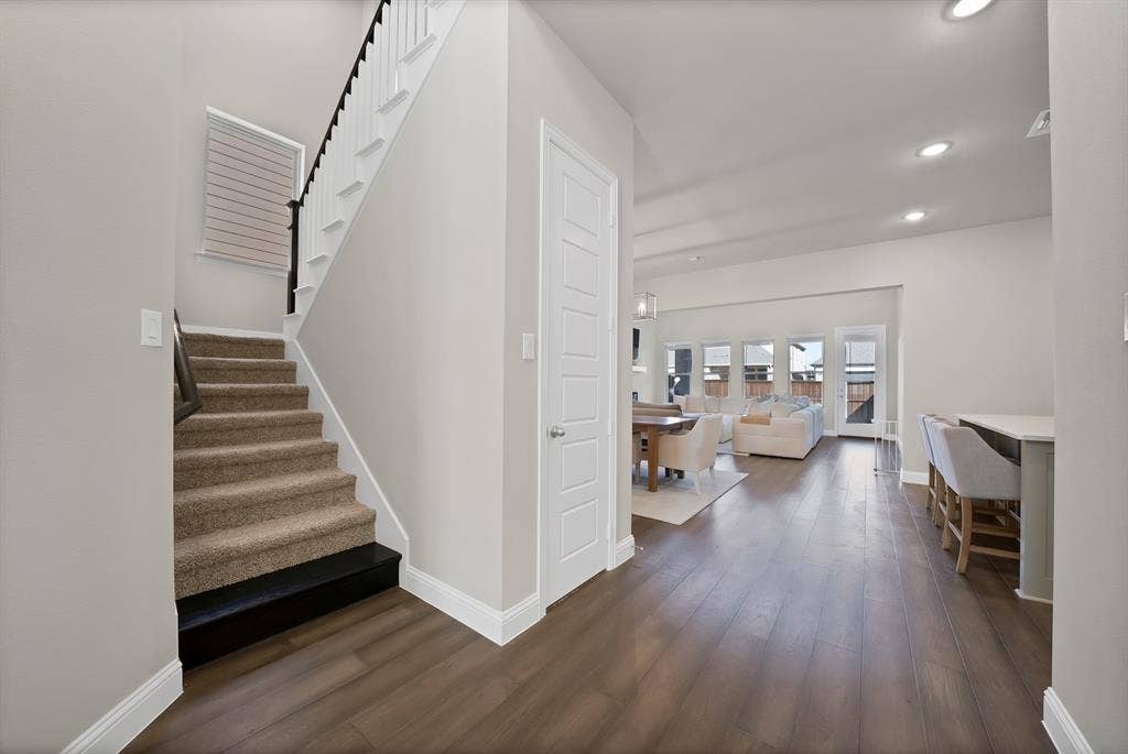 1837 Averi Lane, Farmers Branch, TX 75234 Open-concept living area featuring wood-finish flooring, recessed lighting, and multiple windows