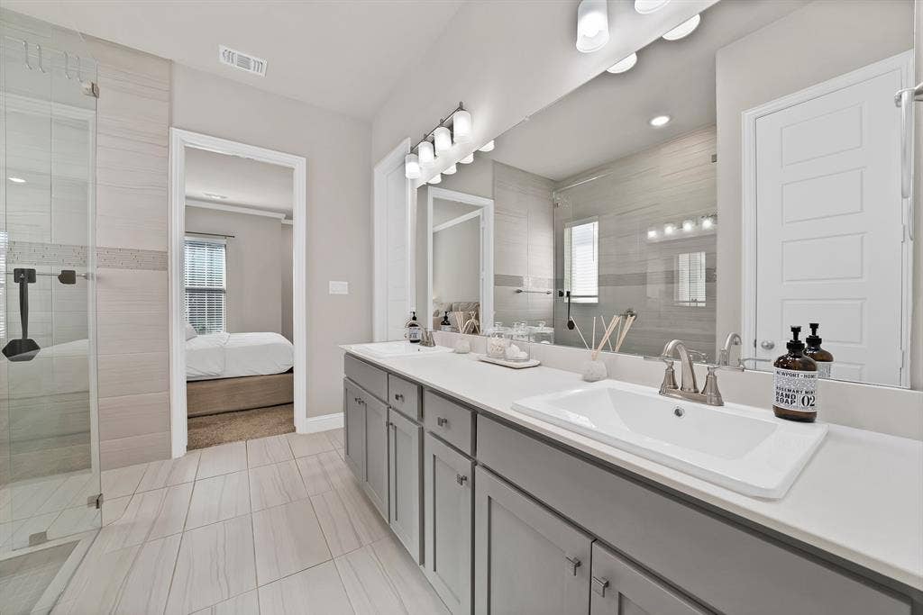 1837 Averi Lane, Farmers Branch, TX 75234 Dual sink vanity with light gray cabinetry, white countertops, and brushed nickel fixtures