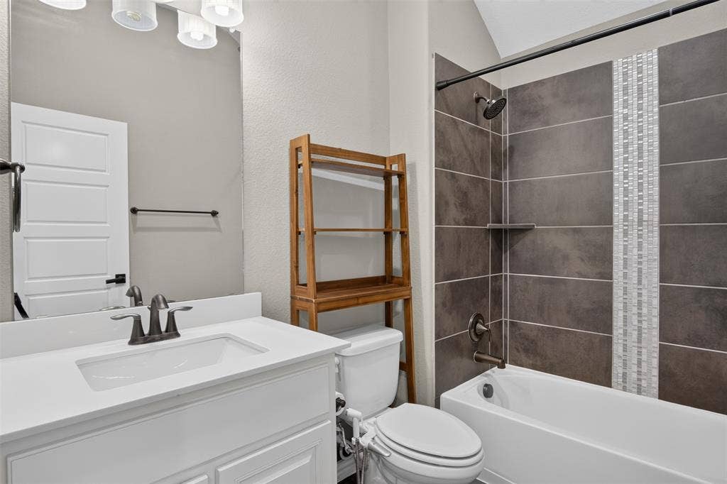 702 Callaway Drive, Allen, TX 75013 White vanity with a rectangular sink, bronze-finish faucet, and overhead lighting