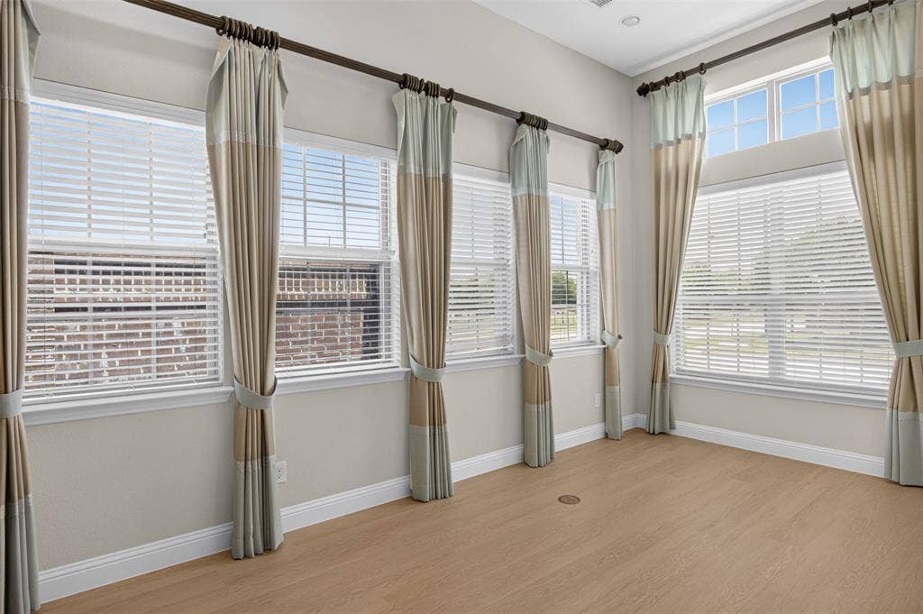 702 Callaway Drive, Allen, TX 75013 High ceilings with transom windows, wood-finish flooring, and white baseboards
