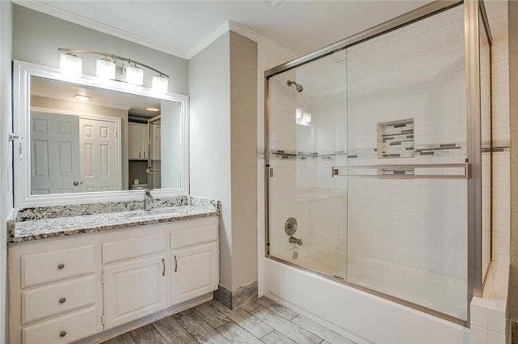 Updated bath with new granite vanity, and new floor.