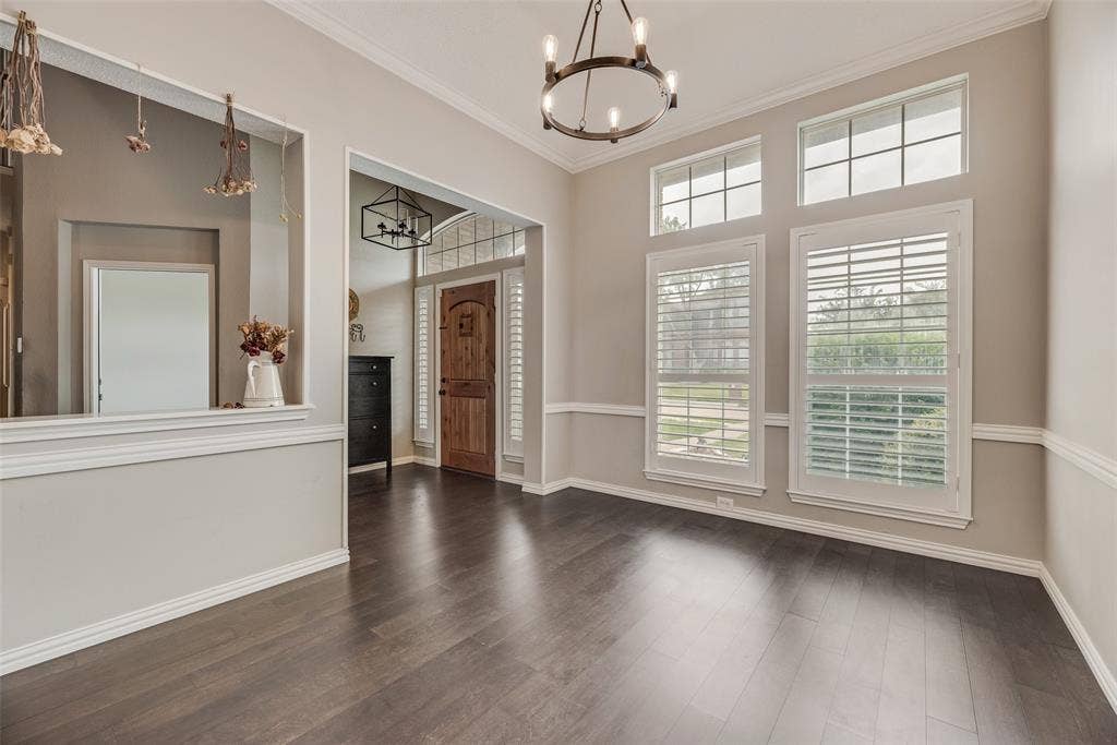 Wood-finish flooring throughout, framed by white crown molding