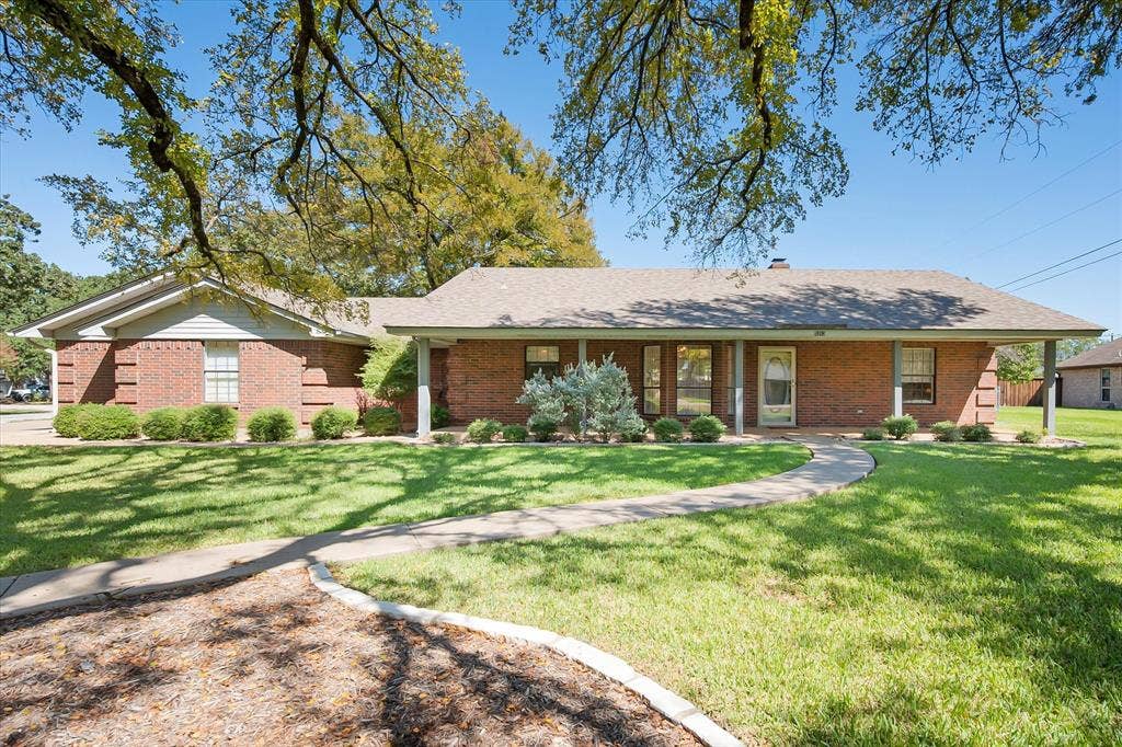 5203 Thunderbird Trail, De Cordova, TX 76049 Brick exterior with a covered front porch featuring white columns