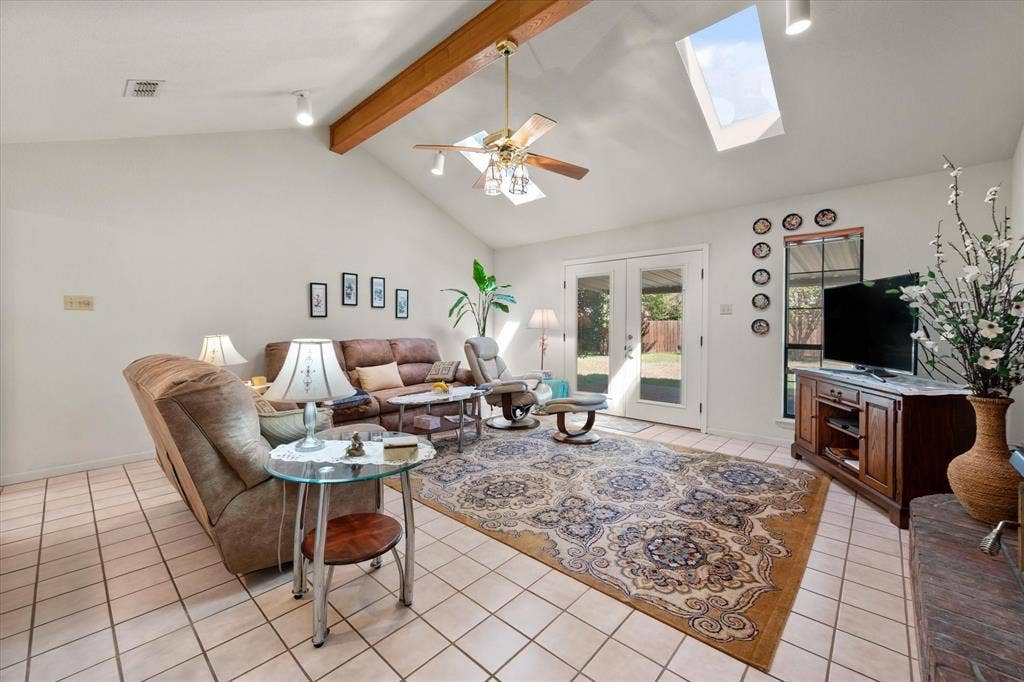 5203 Thunderbird Trail, De Cordova, TX 76049 Vaulted ceiling with exposed wood beam, dual skylights, and ceramic tile flooring