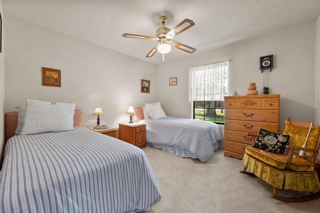 5203 Thunderbird Trail, De Cordova, TX 76049 Neutral wall colors, ceiling fan with integrated lighting, window with privacy coverings, and carpeted flooring