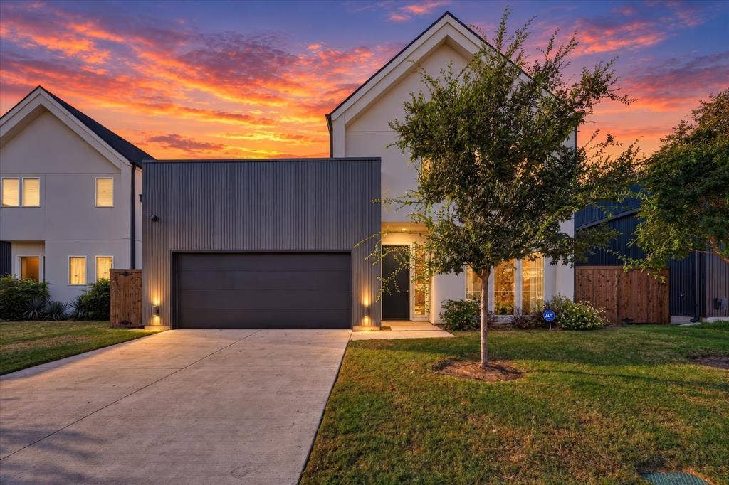 Contemporary exterior with a white facade and dark gray corrugated metal accents
