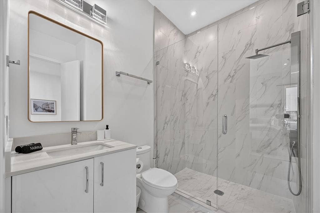 Vanity with a quartz countertop, rectangular undermount sink, and chrome faucet