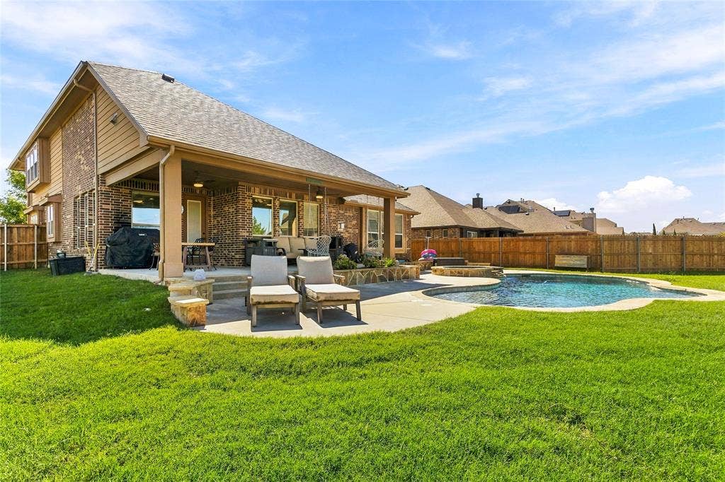 2820 Mariposa Drive, Grand Prairie, TX 75054 Rear exterior showcasing the covered patio and spacious yard.