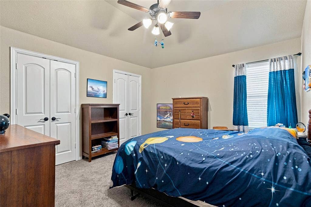 2820 Mariposa Drive, Grand Prairie, TX 75054 Comfortable secondary bedroom with ceiling fan and natural light.
