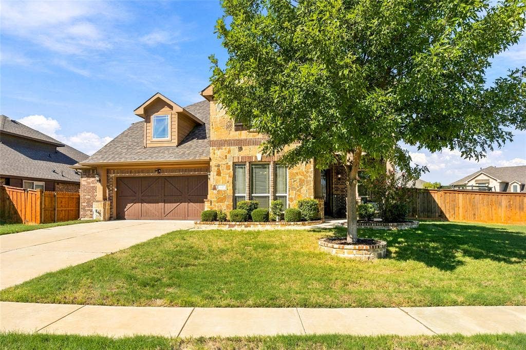 2820 Mariposa Drive, Grand Prairie, TX 75054 Attractive front elevation surrounded by mature landscaping.