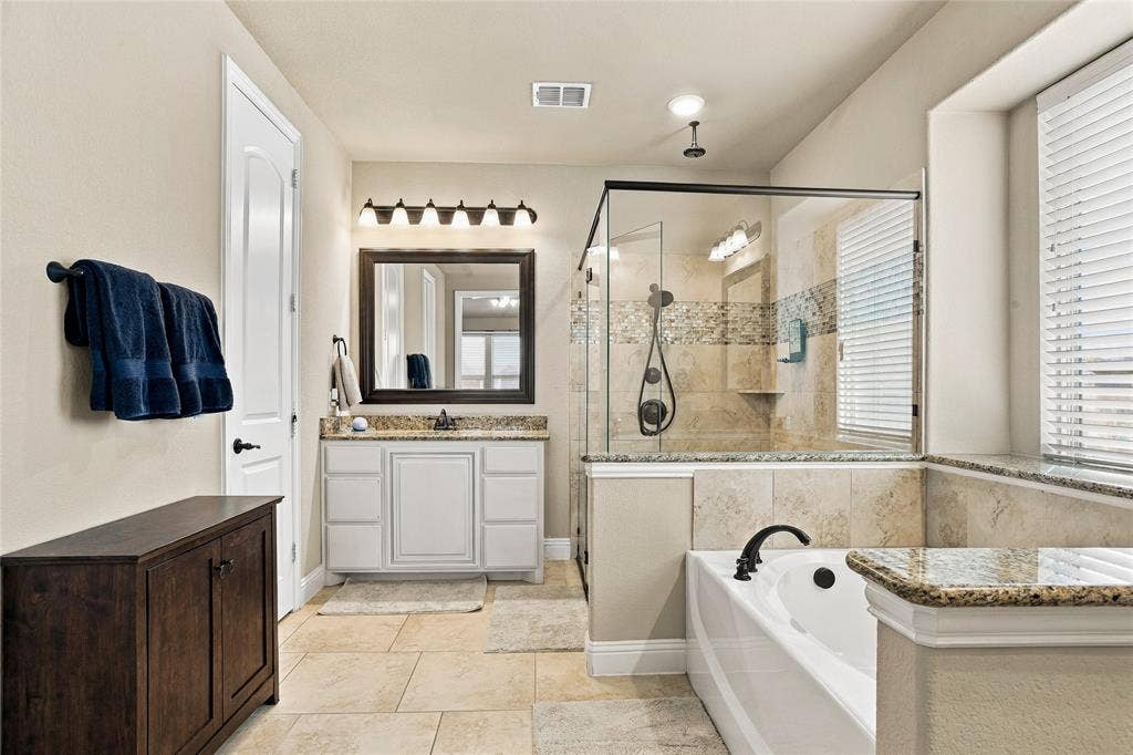 2820 Mariposa Drive, Grand Prairie, TX 75054 Spacious bathroom with separate vanities and a relaxing atmosphere.