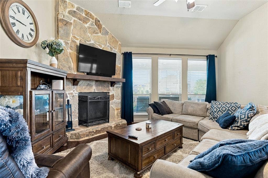 2820 Mariposa Drive, Grand Prairie, TX 75054 Inviting living space featuring a cozy fireplace and abundant natural light.