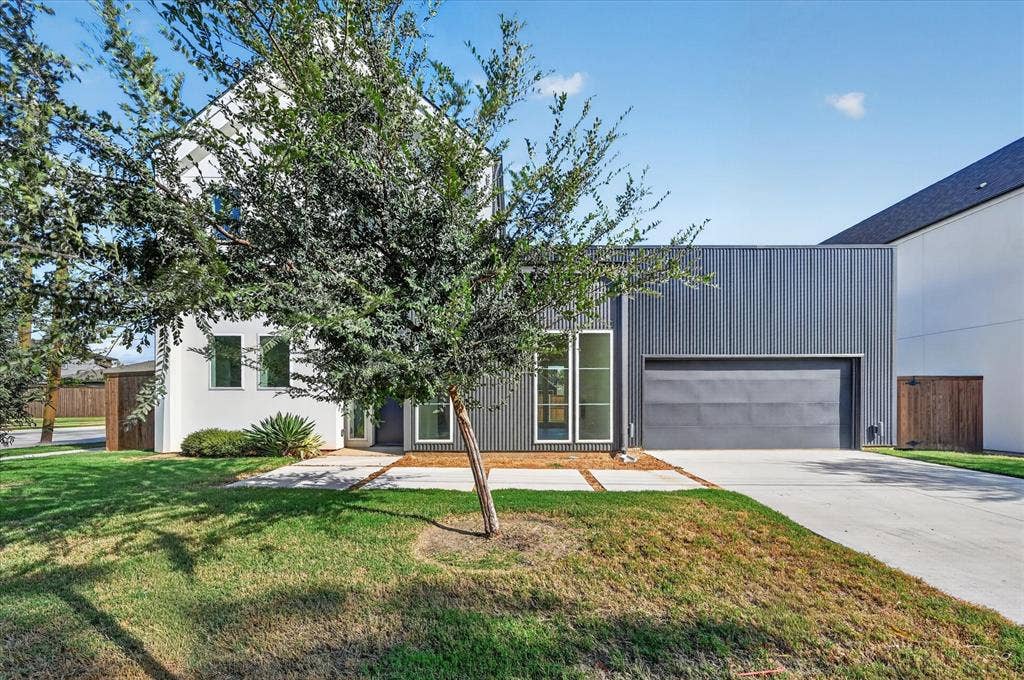 835 Nomas Street, Dallas, TX 75212 Modern residence featuring a clean-lined architectural design with mixed material exterior cladding, including corrugated metal paneling and stucco finishes