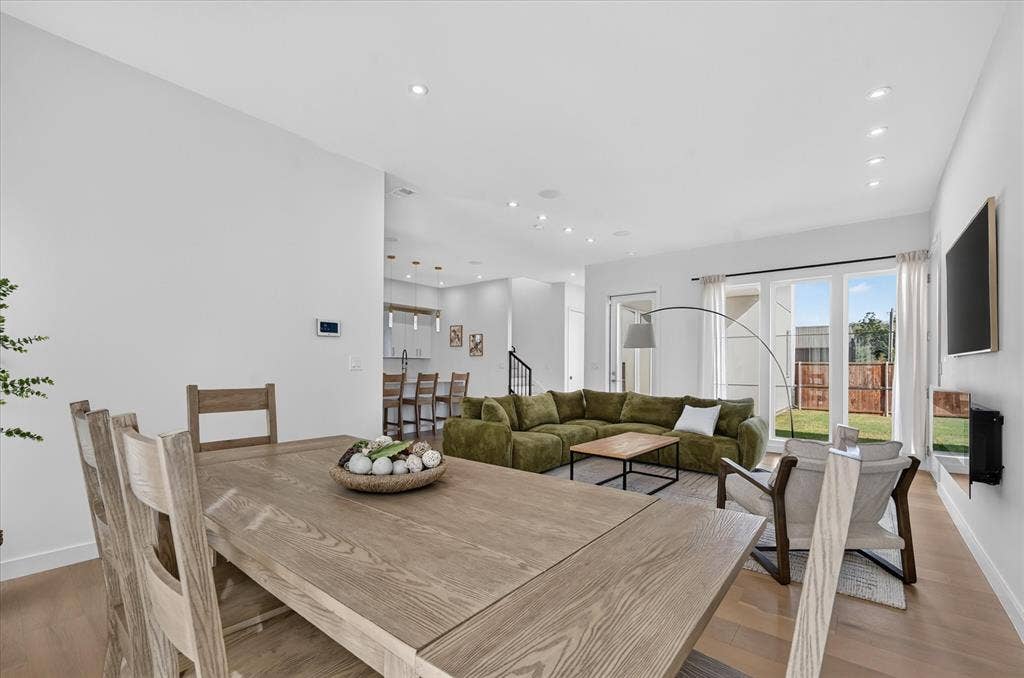 835 Nomas Street, Dallas, TX 75212 Open-concept living space featuring wood-finish flooring, recessed lighting, and expansive glass sliding doors